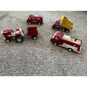 Vintage lot of four metal tonka trucks.